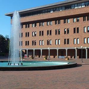 Circle fountain in red square, with Bond Hall (a square brick building) in the background
